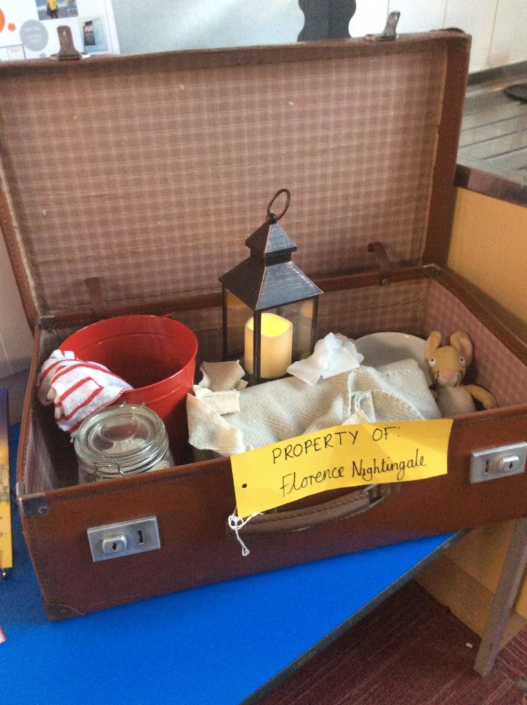 Florence Nightingale's suitcase set up in a classroom to inspire children's imaginations. It has lots of bright and interesting objects in it.