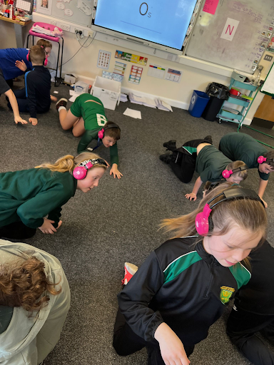 Cheam Farm students use Now Press Play in their classroom. Some of them are crawling on the floor while learning.
