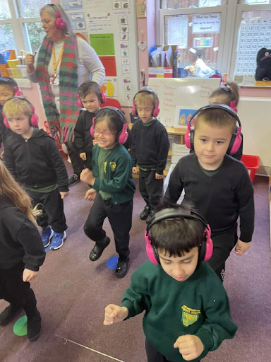 Young Cheam Farm students march along while using Now Press Play in their classroom.