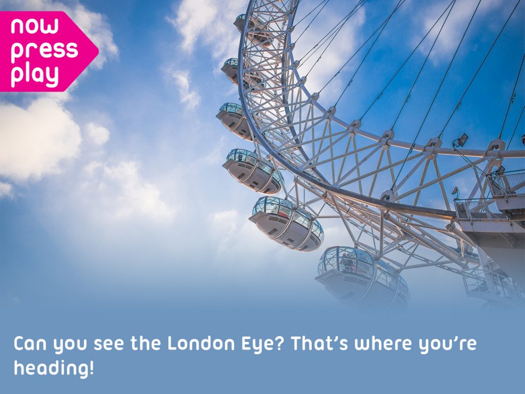 The London Eye against a blue sky, from Now Press Play's SPAG Experience. Caption: Can you see the London Eye? That's where you're heading!