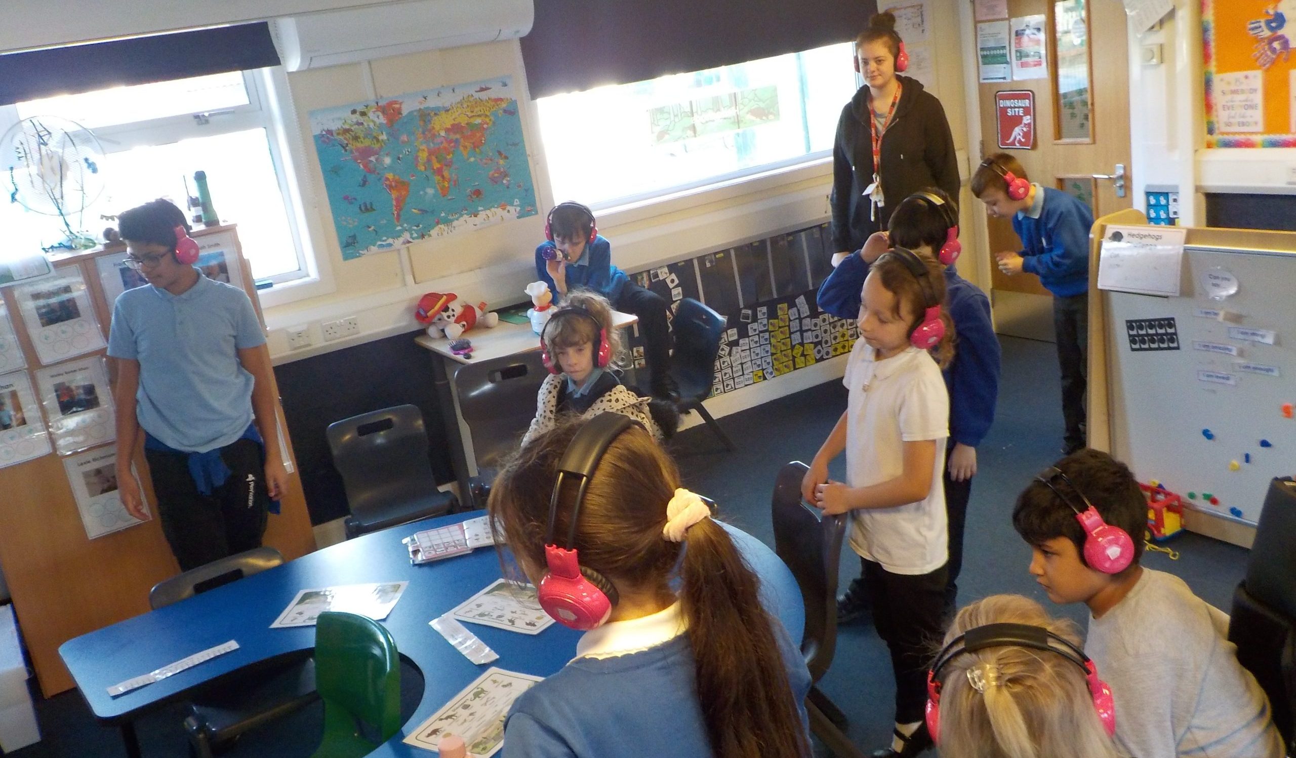 A group of children from Chellow Heights Special School use Now Press Play together in their classroom