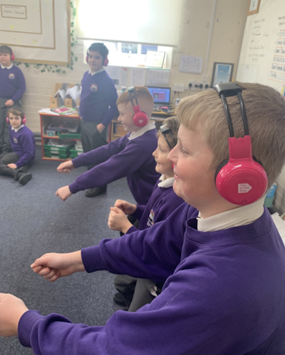 Children at Brompton & Sawdon Primary School smile as they use Now Press Play in their classroom.