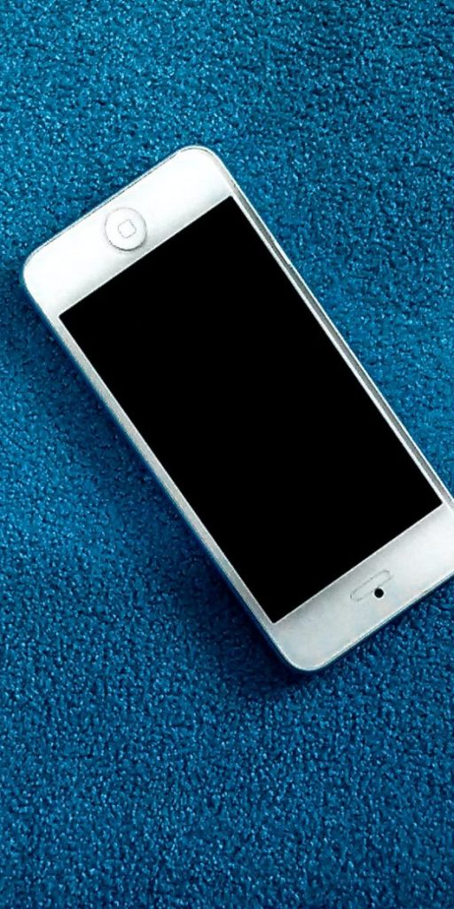 A white iPhone on a blue carpet, from Now Press Play's Anti-Bullying PSHE Experience