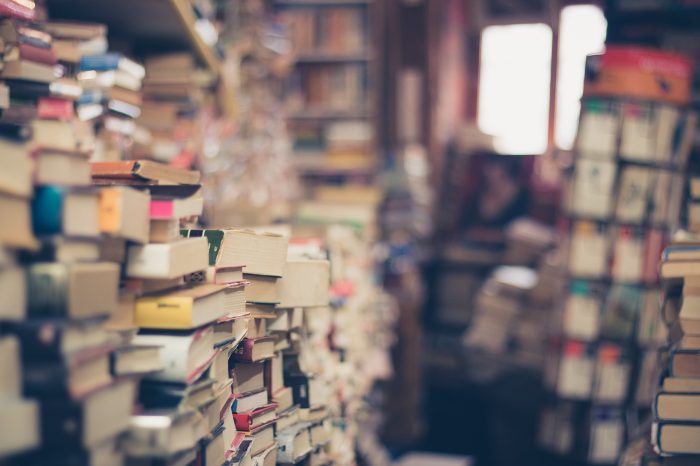 Piles of old books in a library.