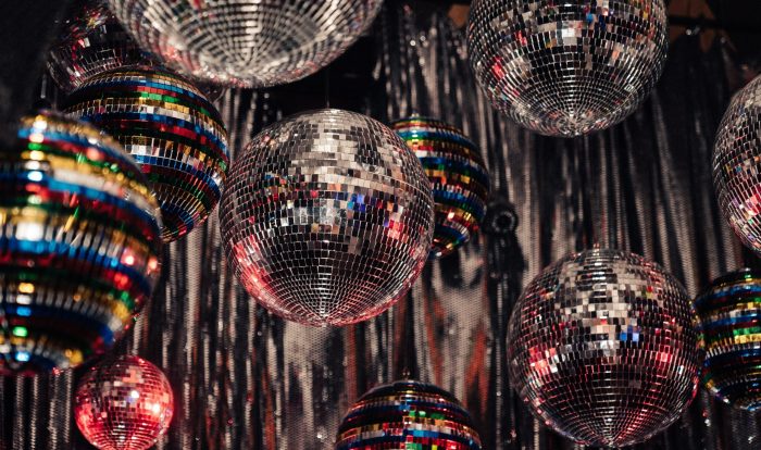 Mirror balls hanging from the ceiling of a dancefloor.